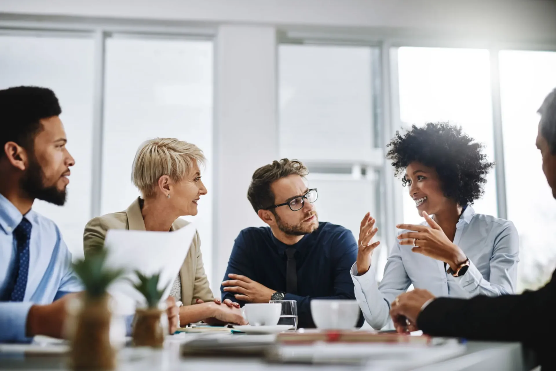 Three colleagues discussing ideas in a modern office setting.